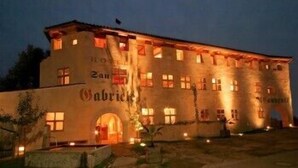 A large, multi-story building with the name "Gabriele" illuminated at the entrance. - Hotel San Gabriele (Rosenheim)