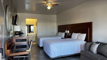 Standard Room with 2 Double Beds & a Sofa Sleeper | Meja kerja, tirai kedap cahaya, setrika/meja setrika, dan seprai linen