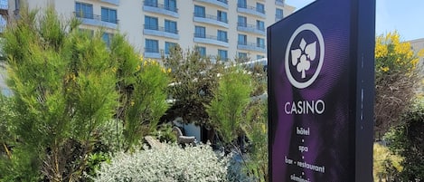 A sign for JOA Casino Hotel Spa with a list of amenities including hotel, spa, bar/restaurant, and seminars.