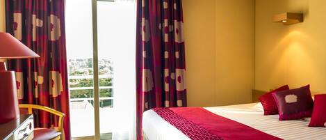 Una camera d'albergo con un letto, una scrivania e una sedia.
