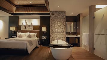 A modern hotel room with a large bed, a bathtub, a vanity with a mirror, and a wooden ceiling.