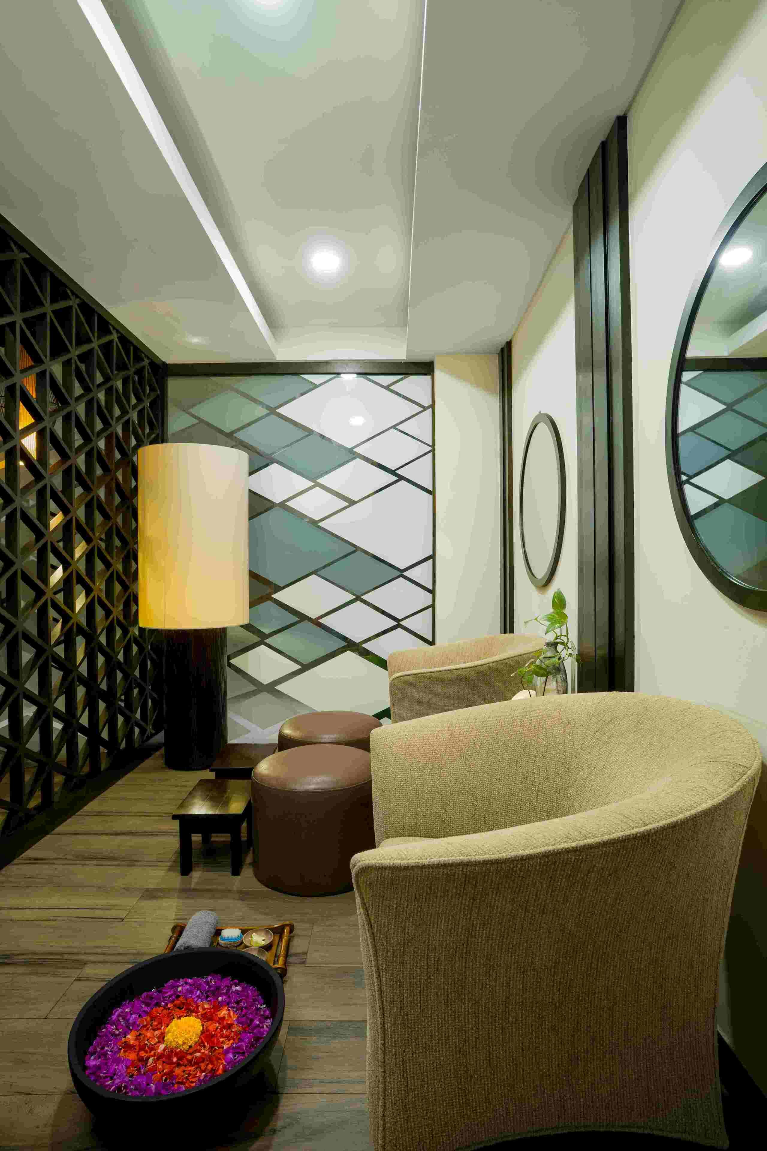 A modern interior with a seating area, a decorative wall, and a floor lamp.