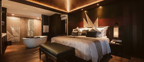 Un dormitorio moderno con una cama grande, un banco, una bañera y un tocador.