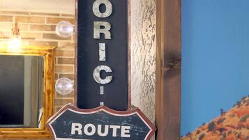 A vintage-style sign with the words "HISTORIC ROUTE 66" mounted on a wall.