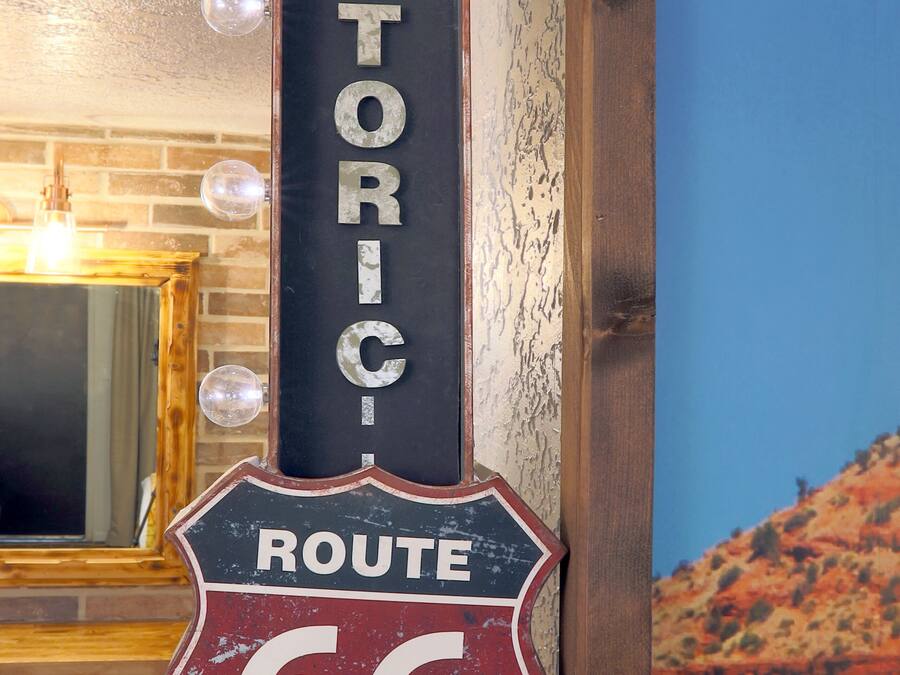 A vintage-style sign with the words "HISTORIC ROUTE 66" mounted on a wall.