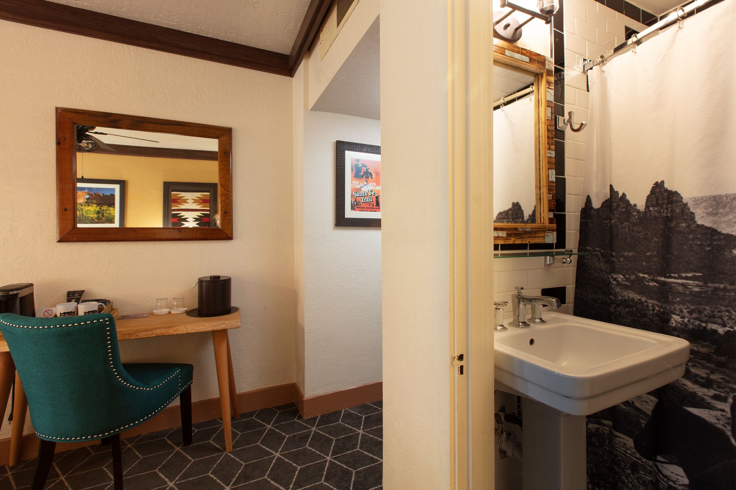 A bathroom with a sink, mirror, and shower curtain.