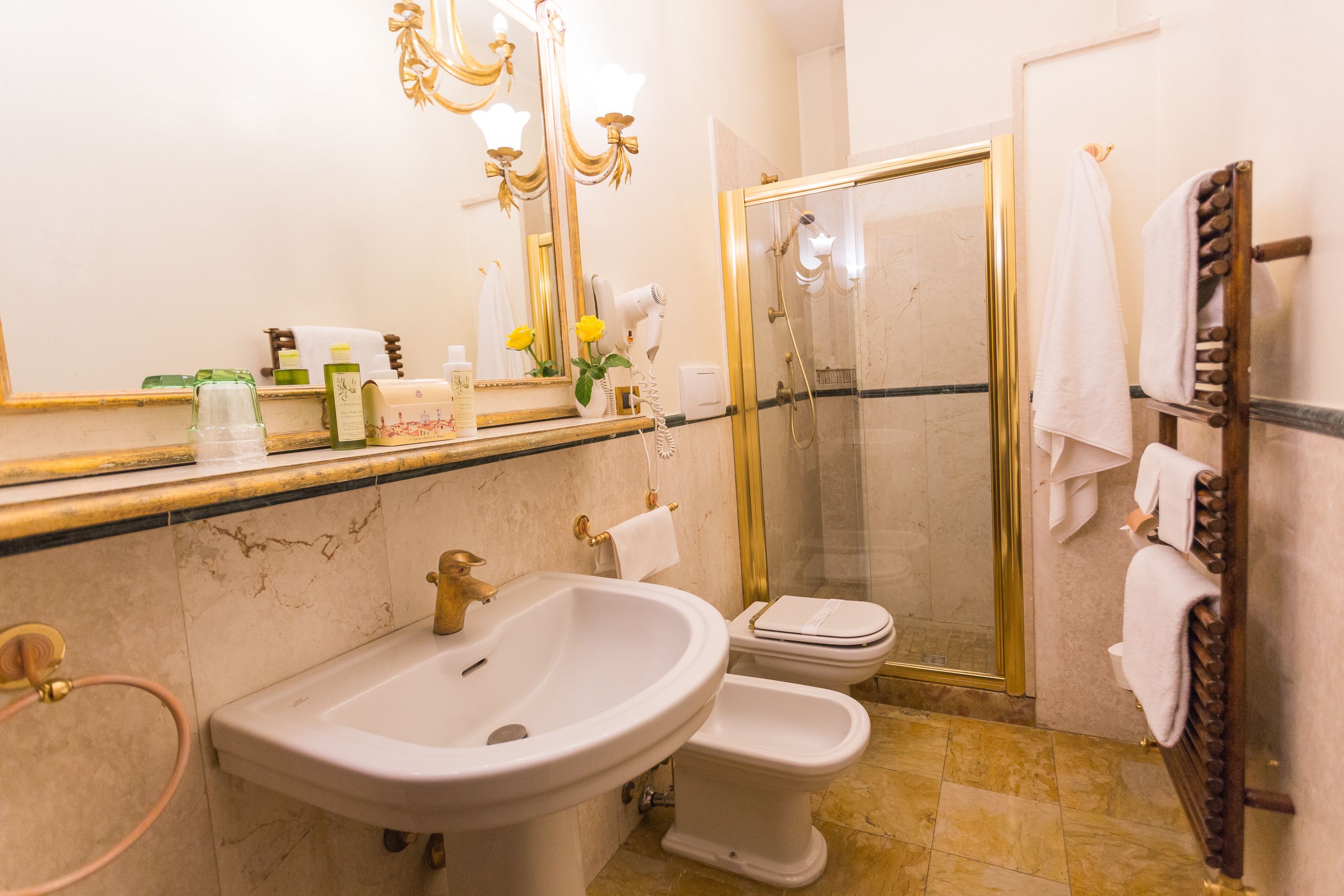 A bathroom with a sink, toilet, and shower.
