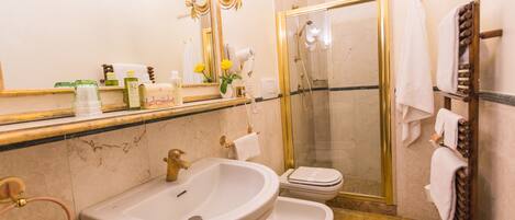 A bathroom with a sink, toilet, and shower.