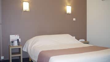 Restful retreat with a neatly made bed and convenient nightstand.