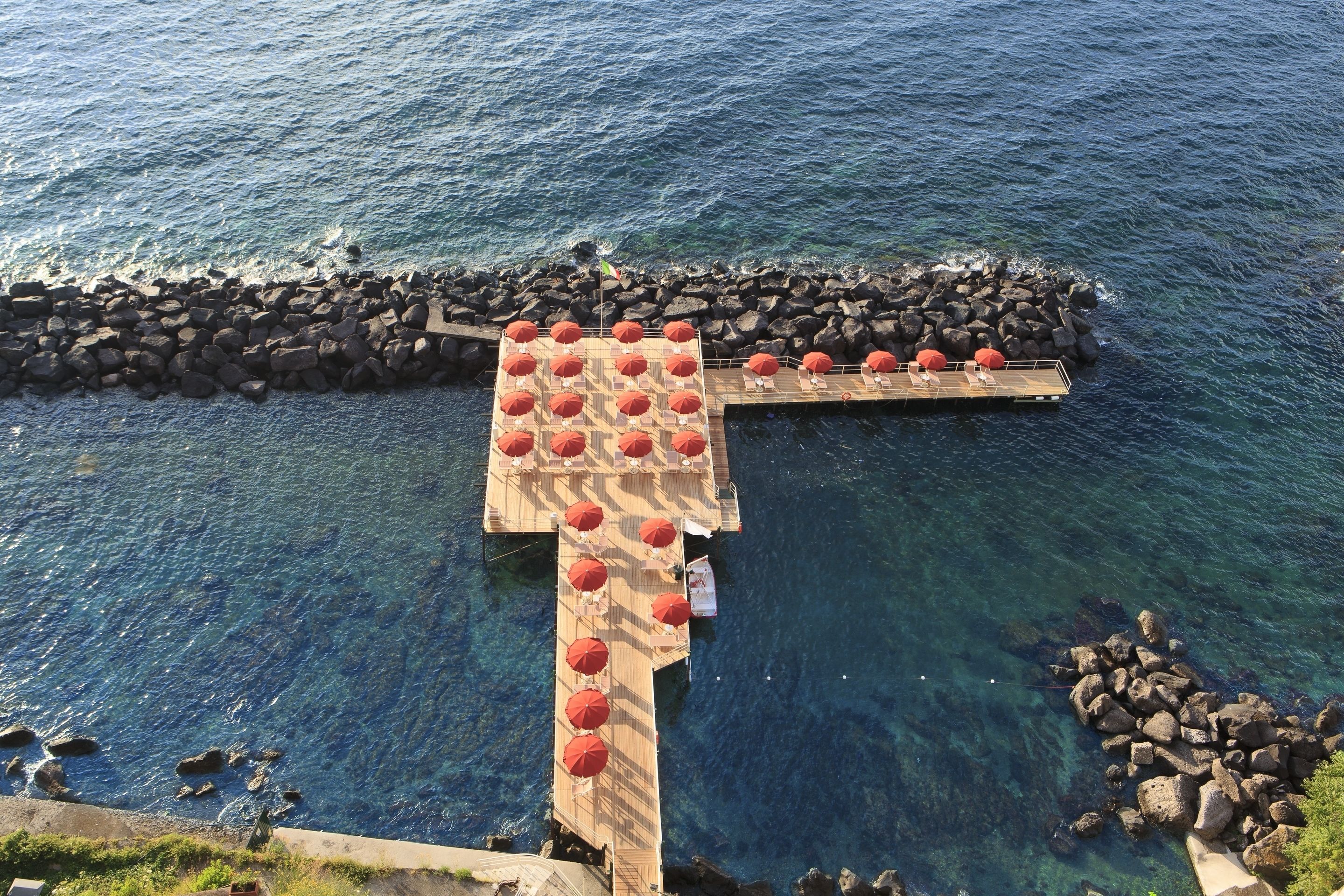 private beach, black sand, sun-loungers, beach umbrellas