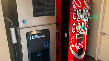 A vending machine with a Coca-Cola logo and an ice dispenser.