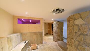 Bathroom features a bench, shower area with glass enclosure, and a small sink.