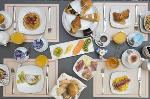 A breakfast buffet with various food items and beverages.