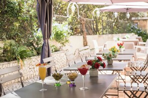 An outdoor dining area with tables, chairs, and umbrellas.