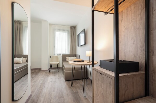 Superior Triple Room | Minibar, in-room safe, desk, laptop workspace