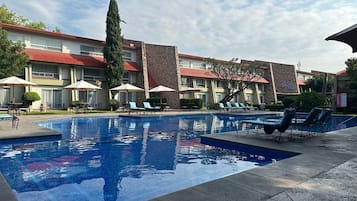 Outdoor pool, open 9:00 AM to 8:00 PM, pool umbrellas, pool loungers