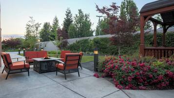 An outdoor patio area with seating and a pergola.