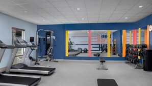 A gym with treadmills, weight machines, and a mirror reflecting the equipment. - Hampton Inn & Suites Clinton - I-26 (Clinton)