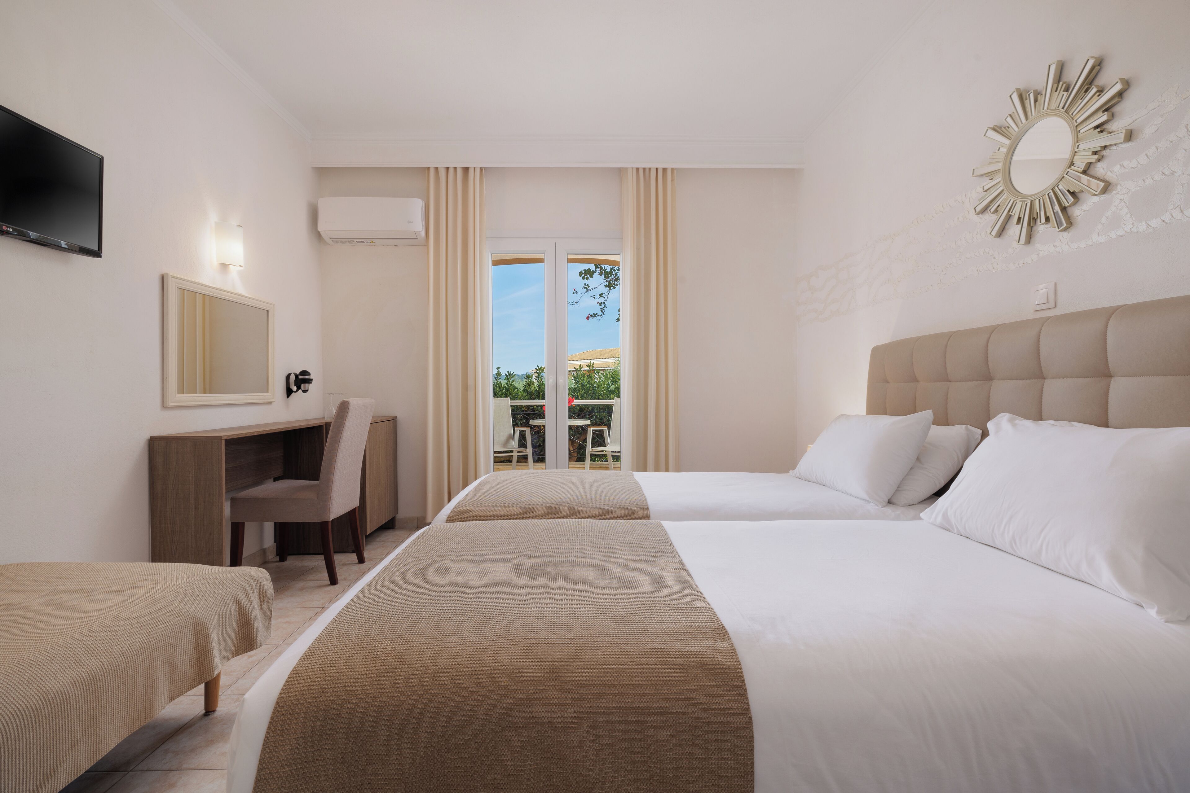 standard triple room, garden view | 1 bedroom, in-room safe, individually decorated, individually furnished