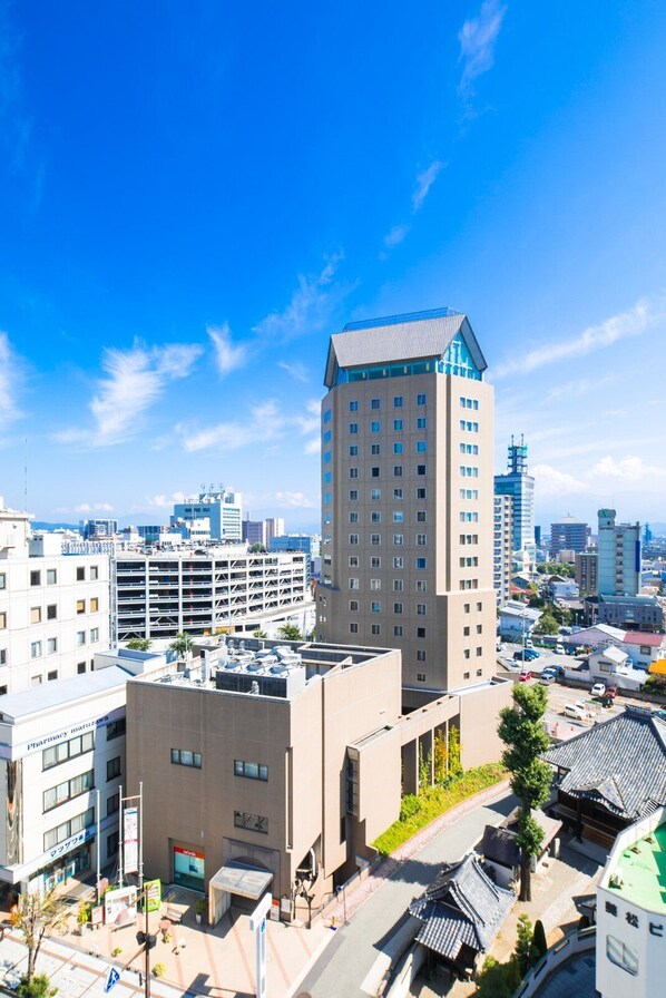 Standing tall in the city, this high-rise building offers a unique blend of contemporary and traditional architecture.