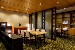 Experience a serene retreat with a traditional Japanese-inspired space featuring a dining table, low cabinet, and comfortable seating.