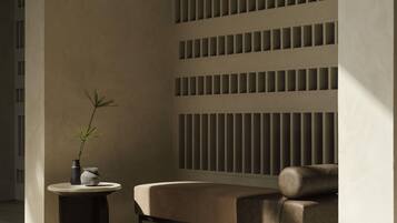 A modern interior with a sofa, a small round table, and a potted plant.