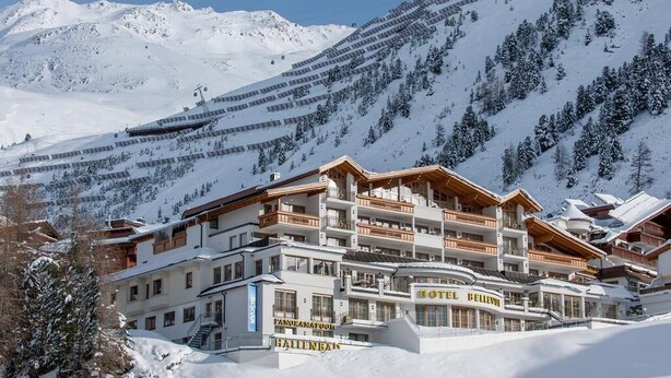 A multi-story hotel with balconies and a ski lift in the background. - Austria Bellevue (Soelden)