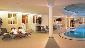 A pool area with lounge chairs and a pool. - Austria Bellevue (Soelden)