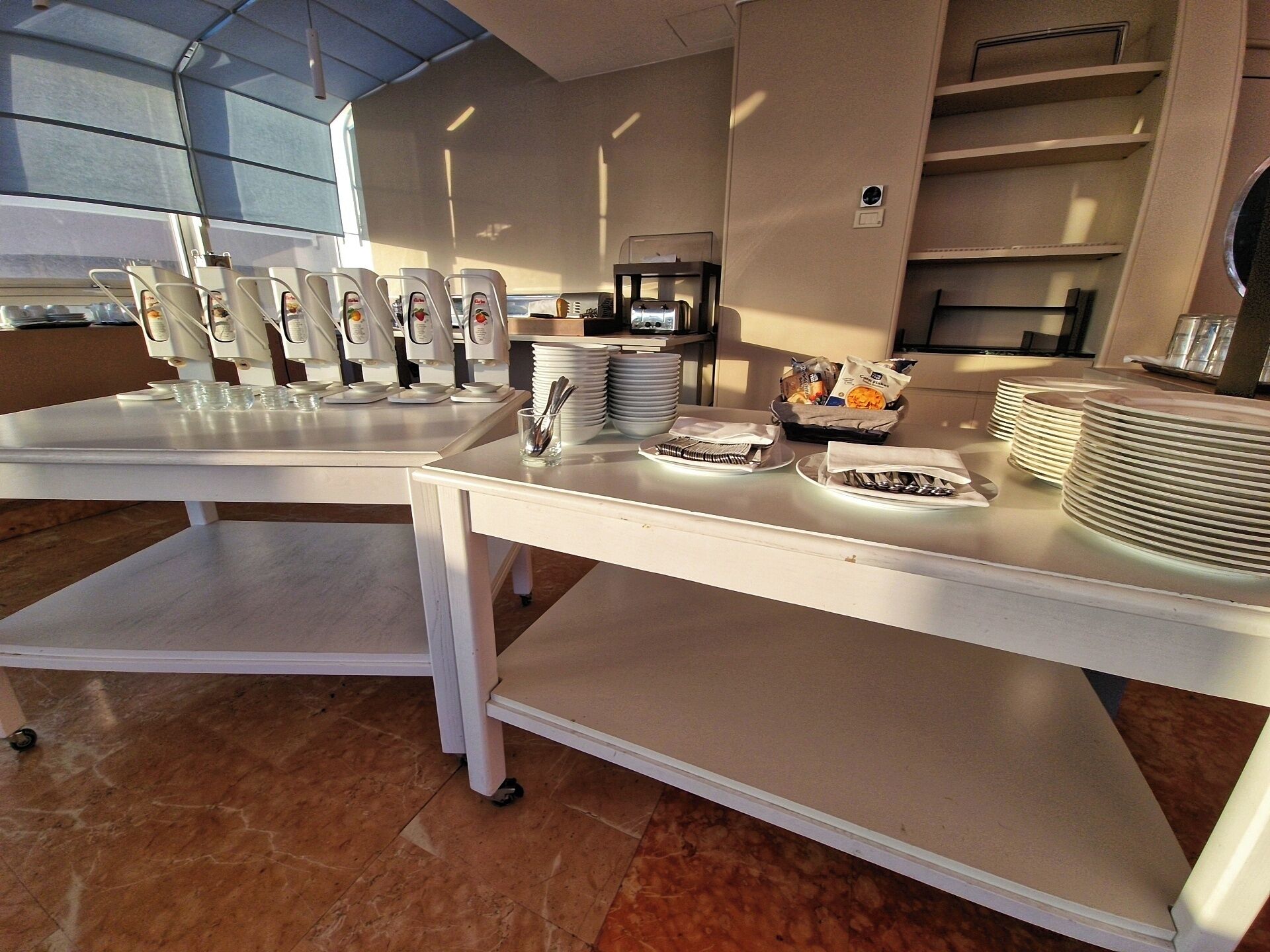 A buffet setup with multiple serving stations, plates, and utensils.