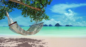 Sur la plage, serviettes de plage, massage sur la plage, kayak