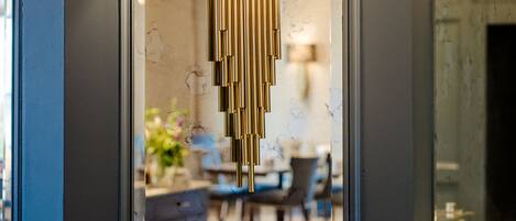 A modern interior with a decorative wall-mounted lamp and a reflective surface.