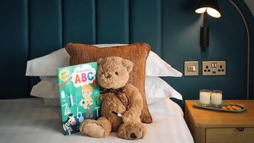 Cozy retreat with a plush teddy bear and a child's book, perfect for a family stay.