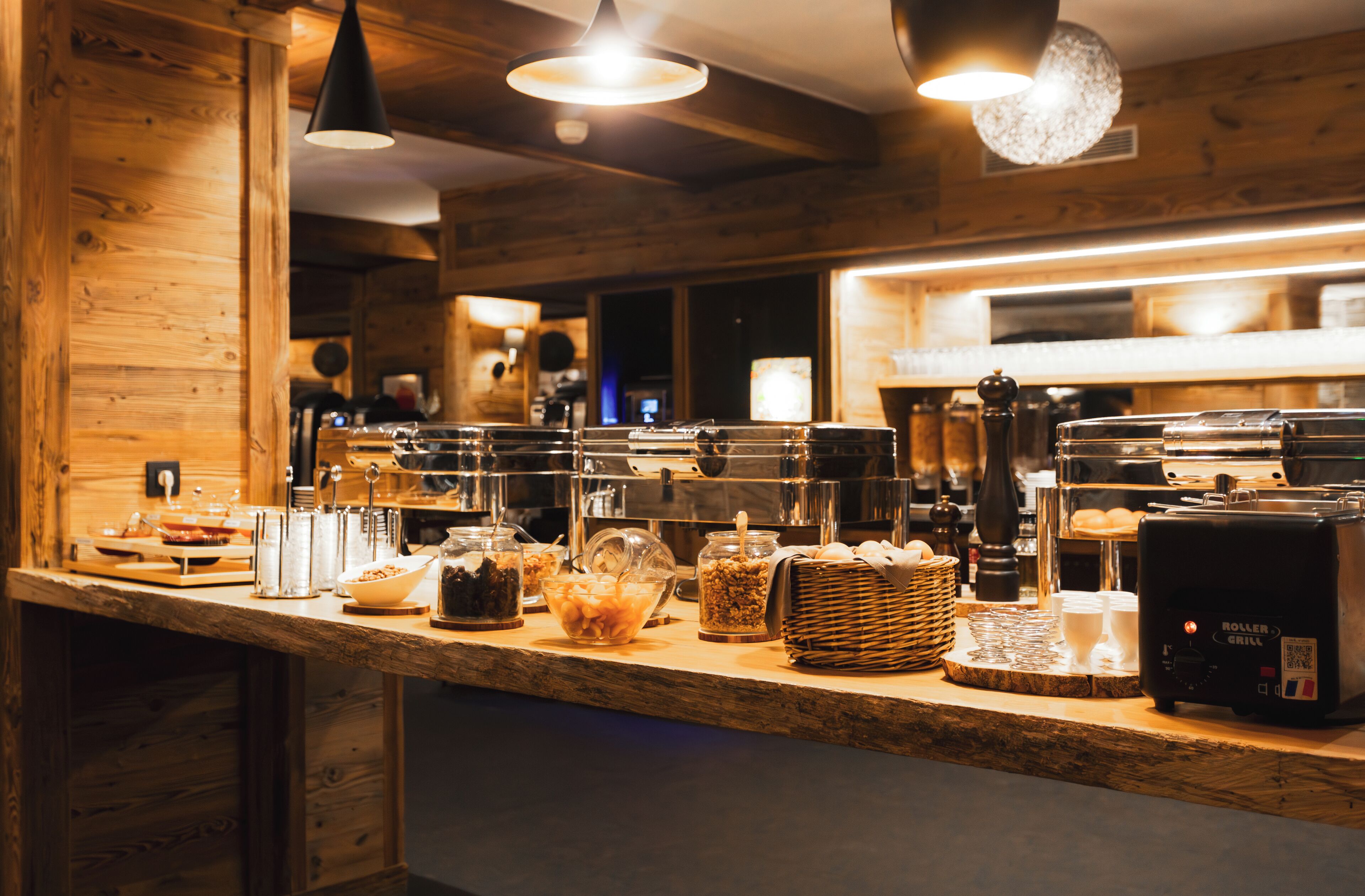 A buffet counter with various food items and a coffee machine.