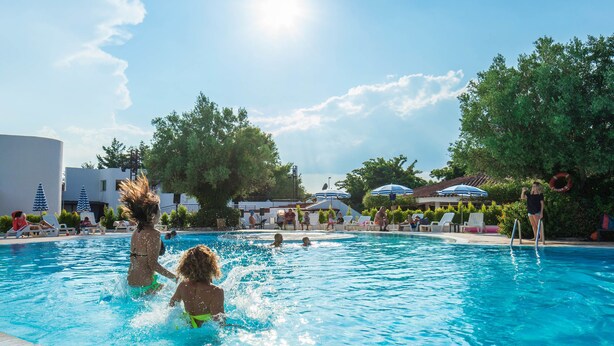 A swimming pool with people in the water, surrounded by lounge chairs and umbrellas. - TH Simeri - Simeri Village (Simeri-Crichi)