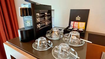 A coffee station with a coffee machine, cups, and a menu.