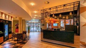A hotel reception area with a check-in desk, seating area, and a self-check-in kiosk. - Best Western Premier IB Hotel Friedberger Warte (Frankfurt)