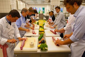 A group of chefs preparing food in a professional kitchen. - Best Western Premier IB Hotel Friedberger Warte (Frankfurt)