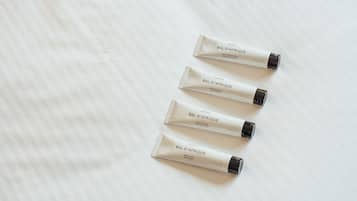 Four tubes of Bal d'Afrique body care products on a white textured surface.