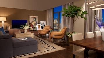A modern living room with a sofa, two armchairs, a coffee table, and a dining table. There is a large window with a city view, a flat-screen TV, and various decorative items including plants and artwork.