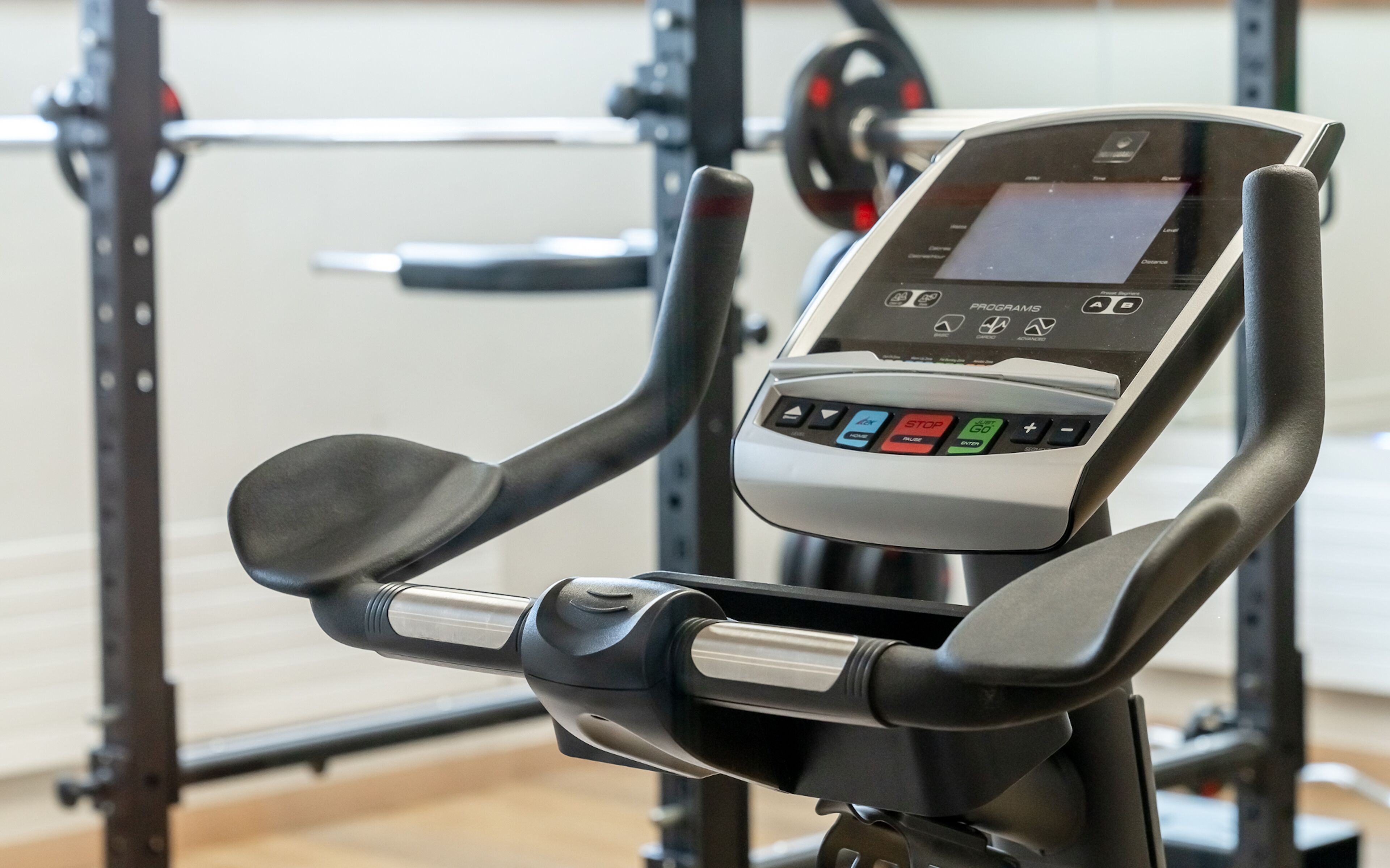 An exercise machine with a digital display and control panel.