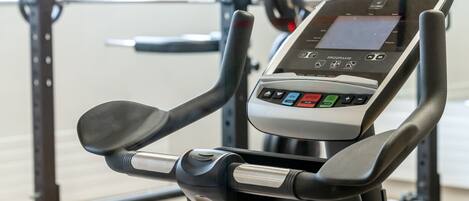 An exercise machine with a digital display and control panel.