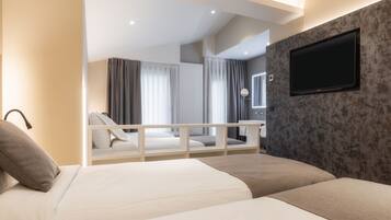 A modern hotel room with a large bed, a TV mounted on the wall, and a balcony with a view of the city.