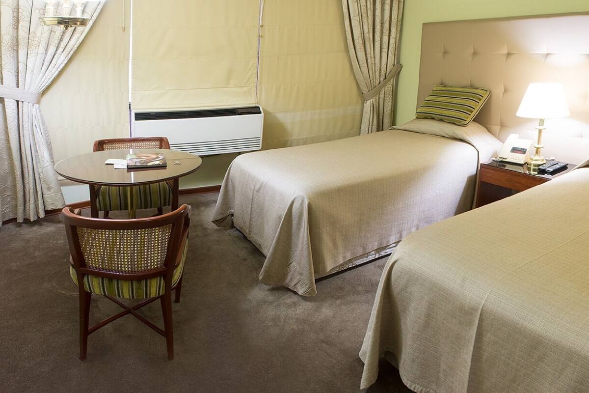 Standard Twin Room | Minibar, in-room safe, desk, iron/ironing board