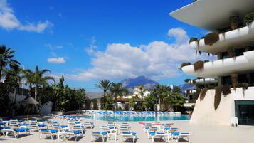 Relax by the pool surrounded by lush gardens and breathtaking mountain views.