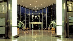 A spacious lobby with a reflective floor, large windows, and modern lighting fixtures. - Gran Hotel Bali (Benidorm)