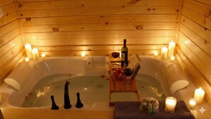 A wooden cabin with a hot tub, candles, and bottles of wine. - Sundowner on Lake George (Lake George)