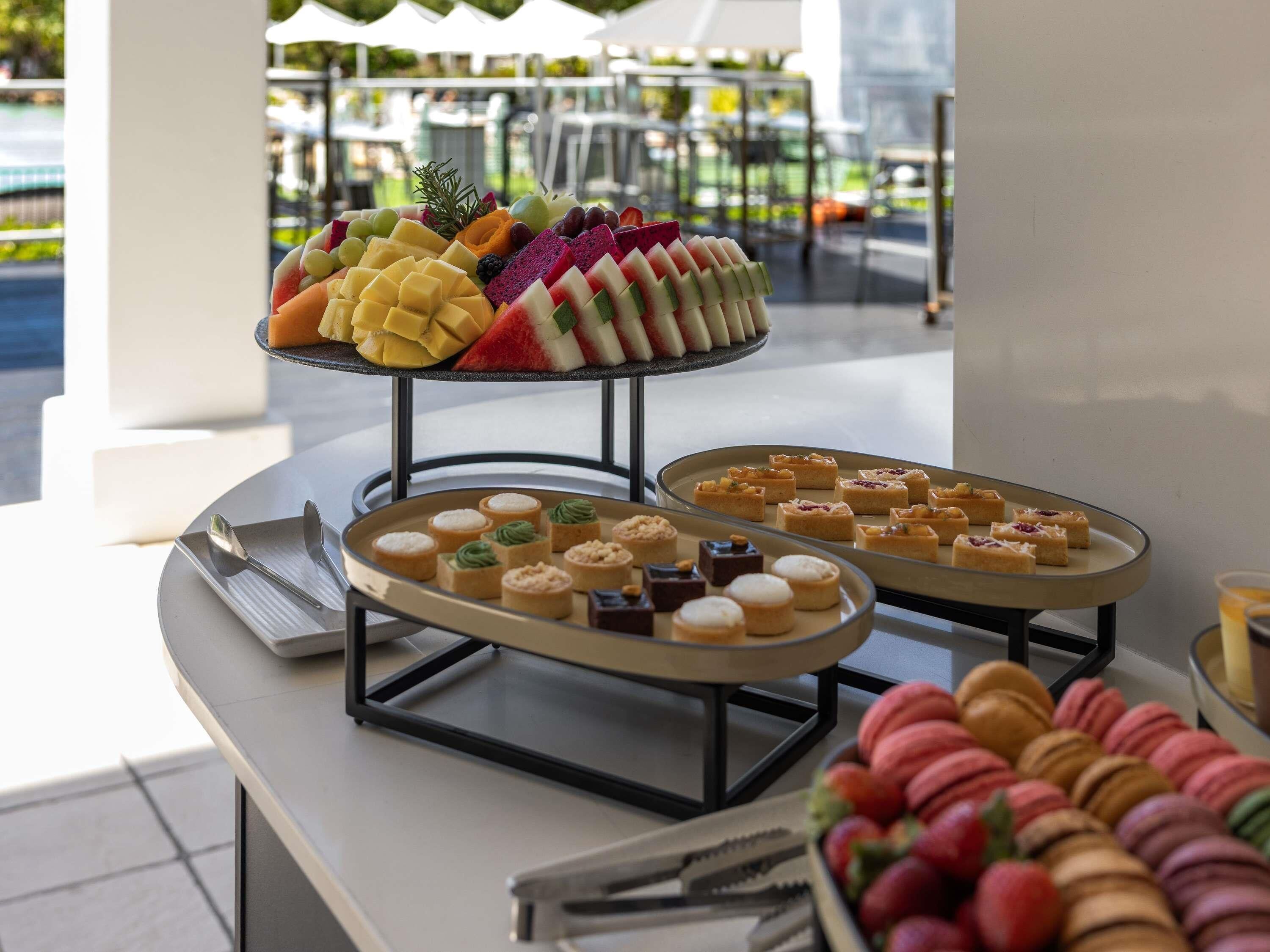 A buffet with various desserts and pastries.
