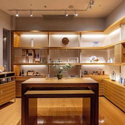 Welcome to our hotel lobby, featuring a central reception desk, seating area, and shelving units.