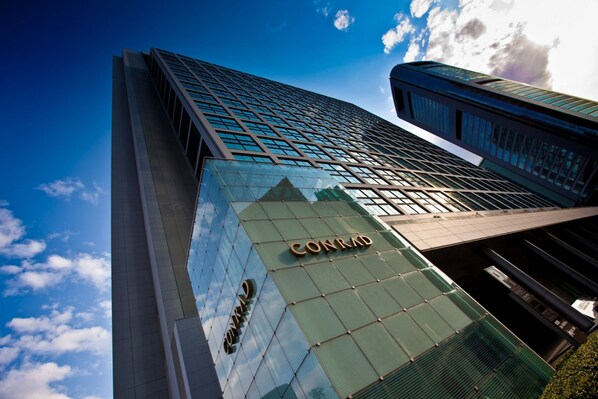A high-rise building with the name "CONRAD" prominently displayed on its facade. - Conrad Tokyo (Tokyo)