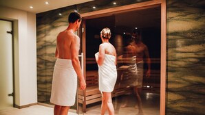 A modern bathroom with a glass shower enclosure and a marble wall. - Ostseehotel Dierhagen (Ostseebad Dierhagen)